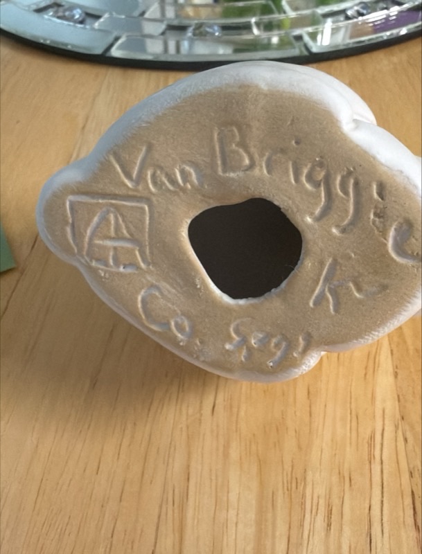 Bottom mark of late commercial Van Briggle rabbit figurine showing squared AA monogram, cursive Van Briggle, Colo. Spgs., and finisher initial on buff clay